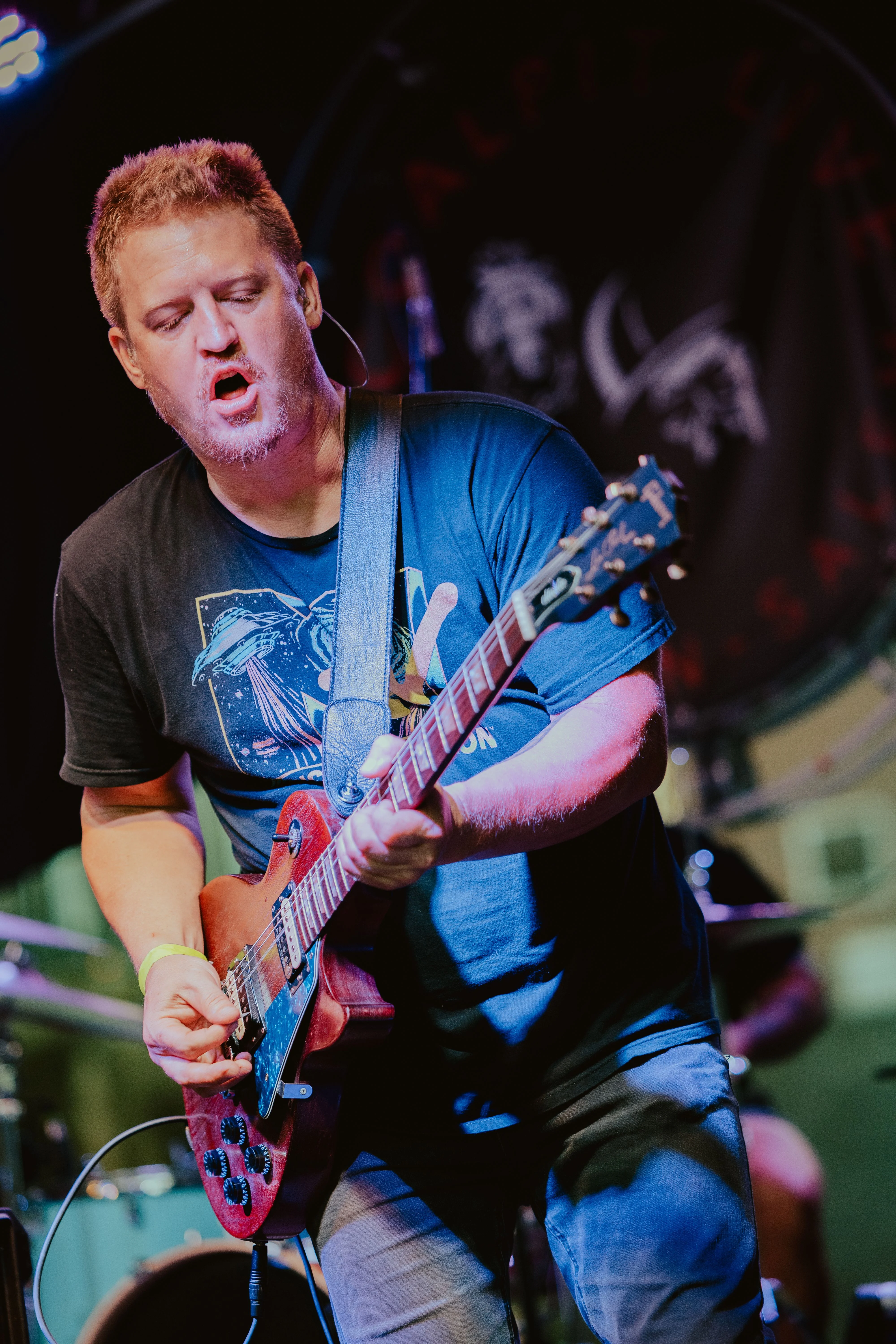 Eric performing guitar with Back To The Start