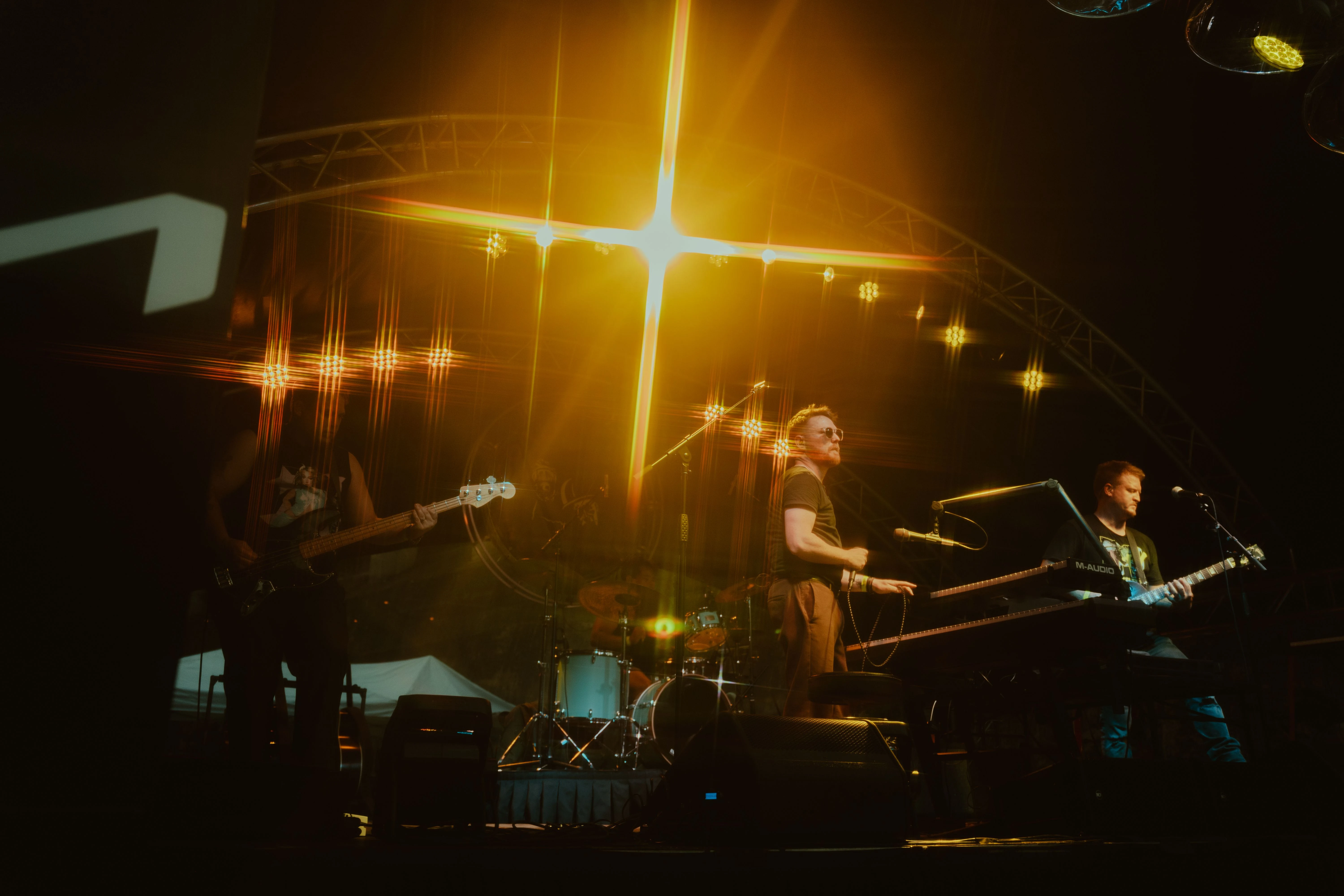 Back To The Start performing live beneath golden stage lights