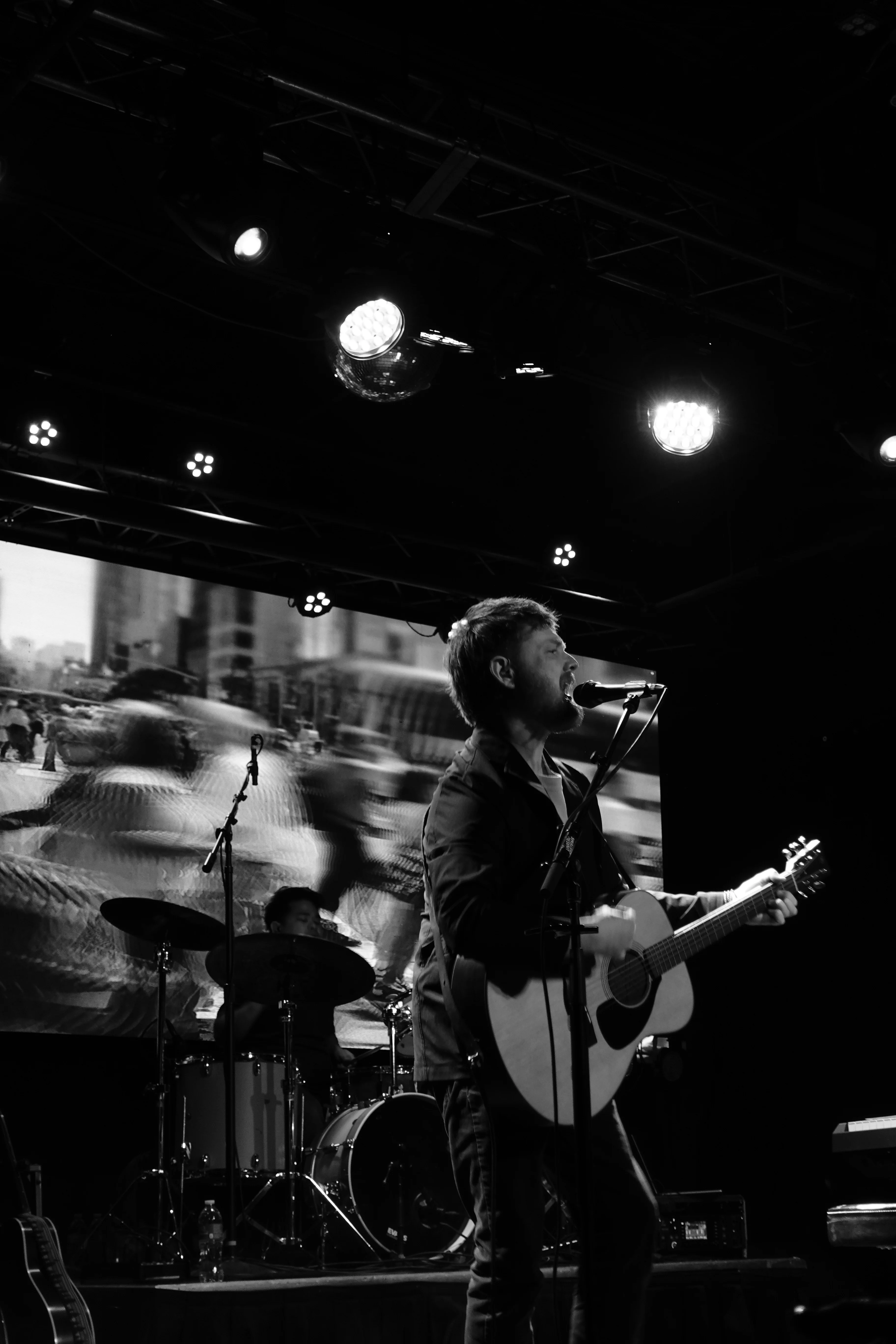 Scott performing in black and white
